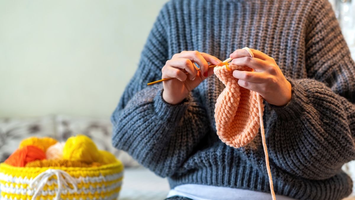 Woman knitting on the bed
